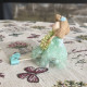 Green decorative Easter doll with flower