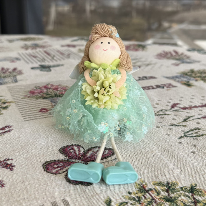 Green decorative Easter doll with flower